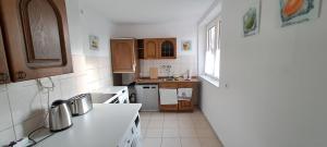 a kitchen with white appliances and wooden cabinets at 40L 3OG r in Castrop-Rauxel