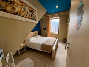 a small bedroom with a bed and a window at White House in Trani +25 photos