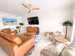 a living room with a couch and a flat screen tv at Destin Harbor Escape in Destin