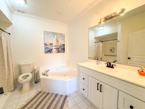 a bathroom with a sink toilet and a mirror at Destin Harbor Escape in Destin +18 photos
