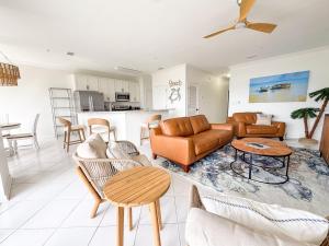 a living room with a couch and a table at Destin Harbor Escape in Destin