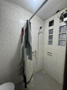 a bathroom with a shower and a toilet in it at laksana homestay in Cireungit +16 photos