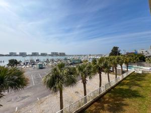a row of palm trees next to a parking lot at Destin Harbor Escape in Destin