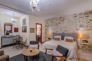 a bedroom with a bed and a living room at Le trente trois in Uzès