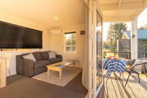 a living room with a couch and a table at The Dales in Twizel