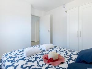 a bed with a hat and a red ribbon on it at Atico Vega Penthouse in Adeje
