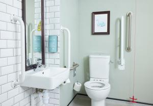 a bathroom with a toilet and a sink at St Leonards Hotel by Greene King Inns in Saint Leonards +39 photos