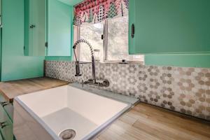 a kitchen with a sink and a window at Gonzalez Cabin in Running Springs +86 photos