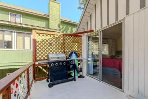 a screened in porch with a grill on a patio at Gonzalez Cabin in Running Springs