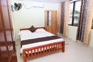 a bedroom with a bed in a room with a window at Rio Casa Homestay in Cochin