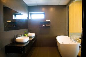 a bathroom with two sinks and a large mirror at Mia Hotel Cửa Lò in Vinh