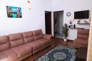 a living room with a couch and a table at Rio Casa Homestay in Cochin