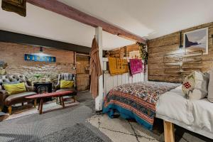 a bedroom with a bed and a table and a chair at One Drake Road Hotel in Tavistock