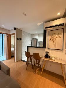 a kitchen and living room with a table and chairs at Belo Apartamento Com Piscina in Várzea Grande