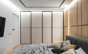 a bedroom with a bed and a wall of sliding doors at Superb 2 Bed Apartment in George Town