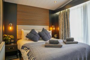 a bedroom with a large bed with two pillows on it at Dawns Rest in Rhayader