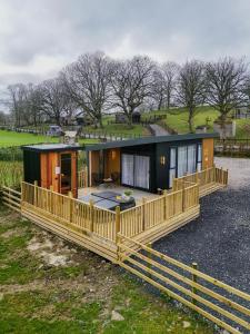 a house with a wooden fence around it at Dawns Rest in Rhayader