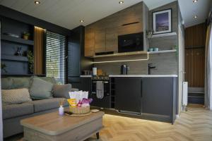 a living room with a couch and a table at Dawns Rest in Rhayader +13 photos