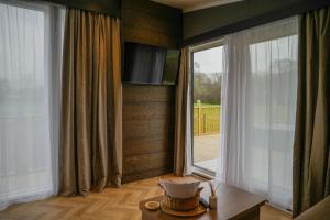 a living room with a large window and a television at Dawns Rest in Rhayader