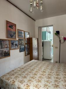 a bedroom with a bed and pictures on the wall at L’Albero Colorato in Candelo