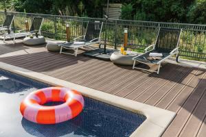 a swimming pool with an orange and white life preserver at The Social Hub Paris La Défense in Puteaux +31 photos