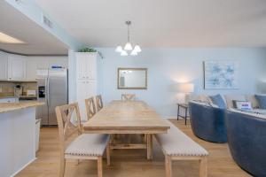 a kitchen and dining room with a table and chairs at Phoenix X 1110 in Orange Beach