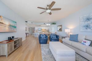 a living room with a couch and a ceiling fan at Phoenix X 1110 in Orange Beach