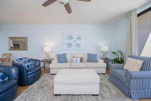 a living room with blue and white furniture at Phoenix X 1110 in Orange Beach