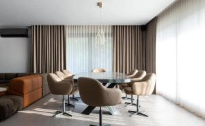 a dining room with a glass table and chairs at Superb 2 Bed Apartment in George Town