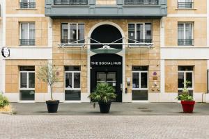 a building with a sign that reads the scottinian inn at The Social Hub Paris La Défense in Puteaux