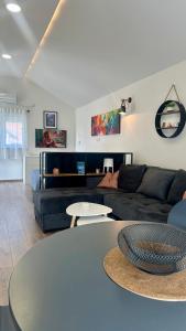 a living room with a couch and a table at Lane Stay Studio in Beograd