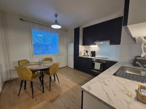 a kitchen with a table and chairs in a room at Azure Nordic Retreat in Rauma