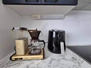two appliances sitting on a counter in a kitchen at Azure Nordic Retreat in Rauma