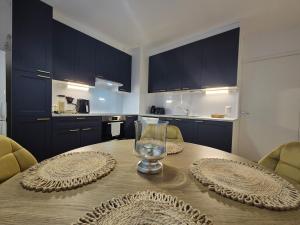 a kitchen with a wooden table with a glass on it at Azure Nordic Retreat in Rauma +20 photos