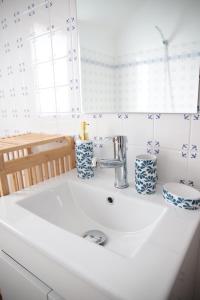 a white sink with blue and white vases on it at Au repos des elfes in Braye-sous-Faye +136 photos