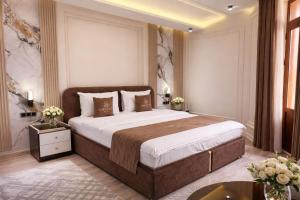 a bedroom with a large bed in a room at AMIR PLAZA hotel in Akmechetʼ