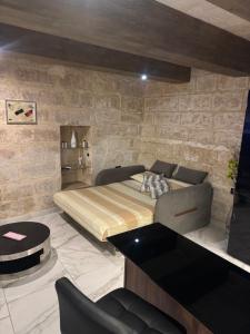 a bedroom with a bed and a table and chairs at rabat apartment in Rabat