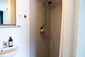 a bathroom with a shower with a sink at Hotel Ribe in Ribe