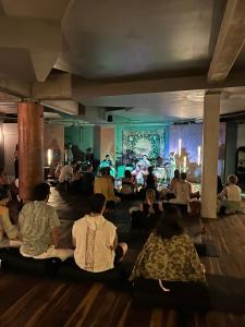 a group of people sitting on the floor watching a concert at Calea Tulum Boutique Hotel in Tulum +156 photos