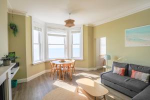 a living room with a couch and a table at Seaview in Worthing