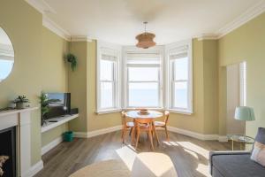 a living room with a table and a couch at Seaview in Worthing