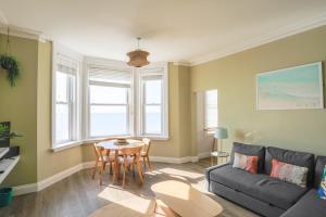 a living room with a couch and a table at Seaview in Worthing +21 photos