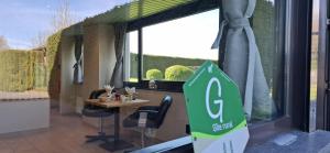 a sign in a room with a table and a window at Bulle d'eau in Gouvy