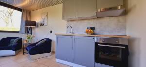 a kitchen with a counter and a sink and a stove at Bulle d'eau in Gouvy
