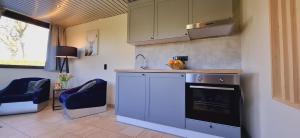 a kitchen with a sink and a stove top oven at Bulle d'eau in Gouvy +35 photos