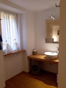a bathroom with a sink and a mirror at Casa Edo in Ponte Tresa