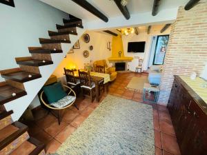 a living room with a staircase and a dining room at Casa Isabel in El Gastor