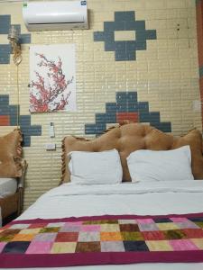 a bedroom with a bed with a blanket on it at THANH XUAN Hotel in Sapa
