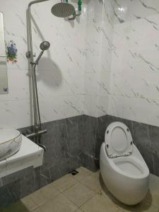a bathroom with a white toilet and a sink at THANH XUAN Hotel in Sapa