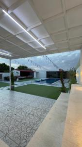 a pavilion with a pool and a tennis court at Ghala Farm in Adh Dhayd